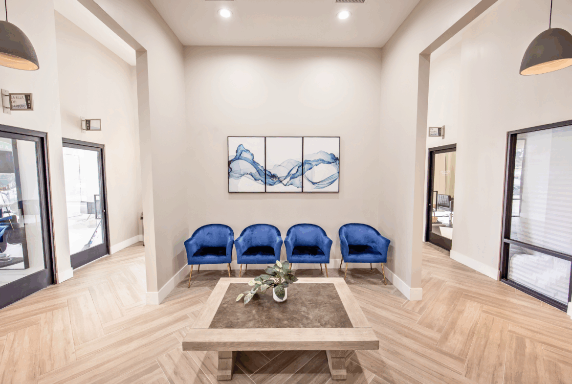 Elegant salon reception area with trendy blue salon chairs and minimalist decor.