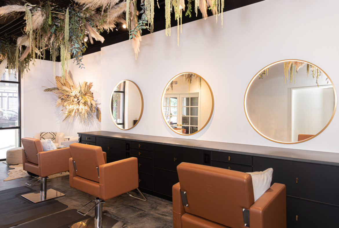 Modern salon with stylish furniture, large mirrors, and fresh decoration for a welcoming vibe.