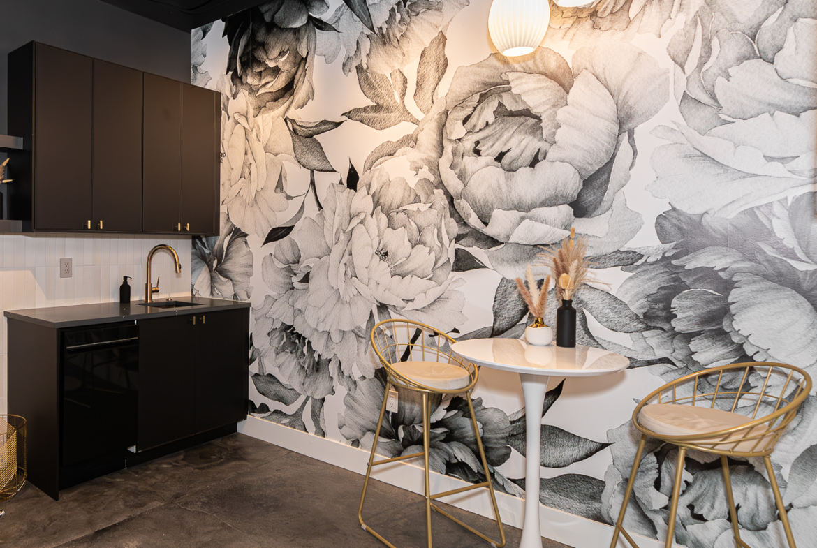 Stylish salon interior with floral wallpaper, modern furniture, perfect for rent or leasing.