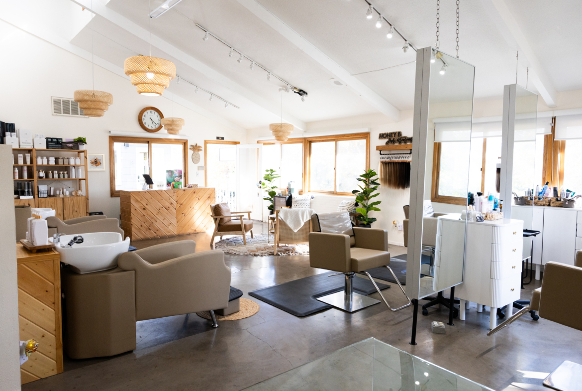 Bright, inviting salon interior with seating, hair stations, and natural light.