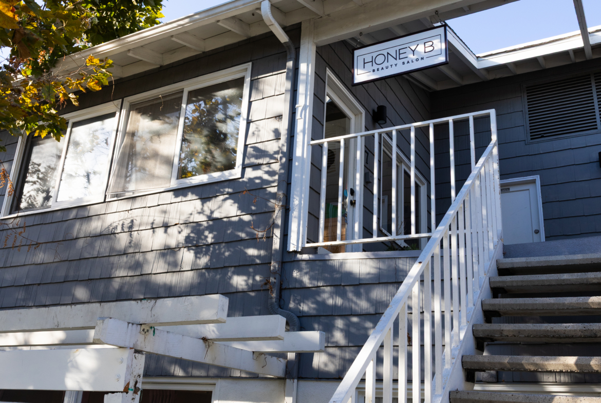 Exterior of Salon Renter with stairs, signage, and commercial building for beauty salons.