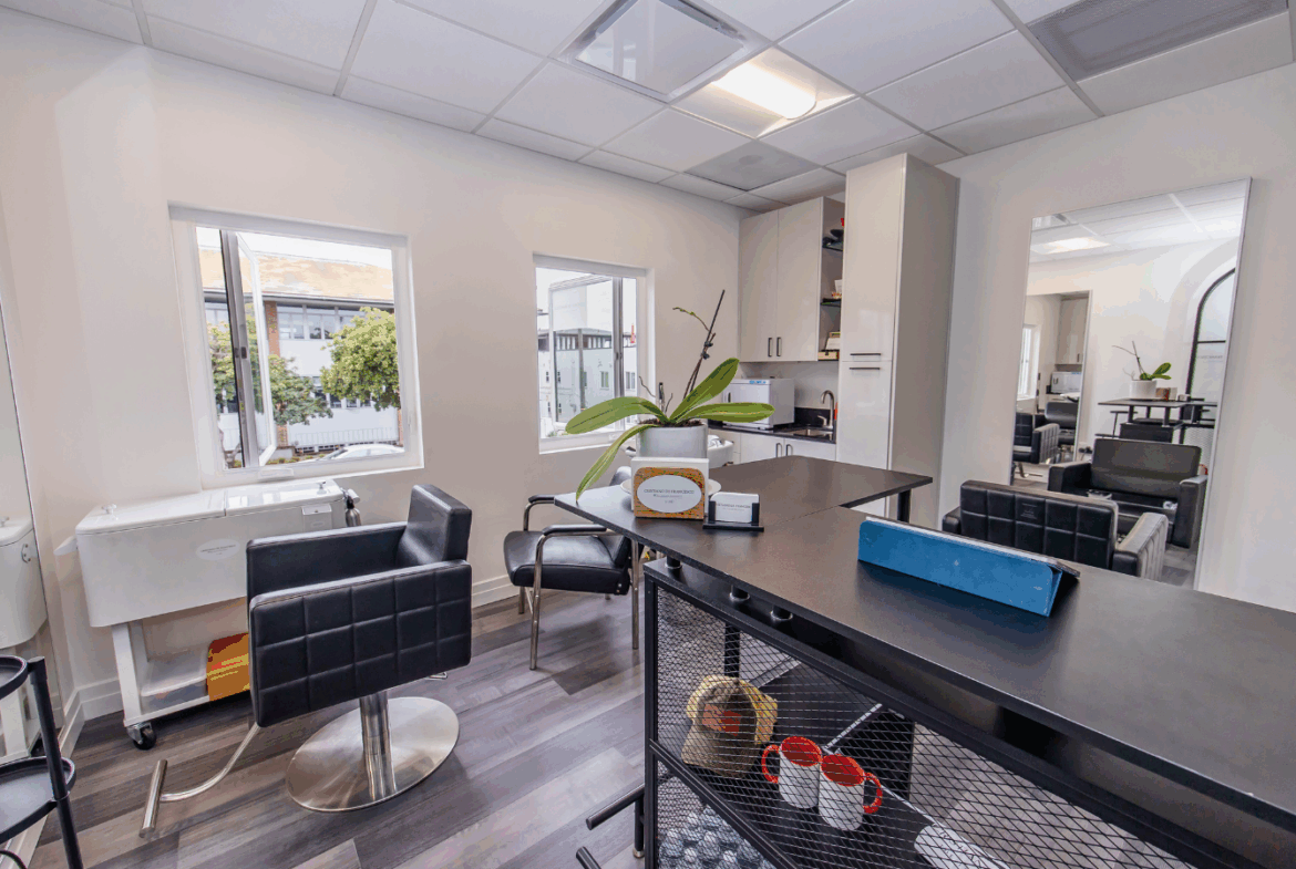 Bright salon with styling chairs, large windows, and a welcoming atmosphere.