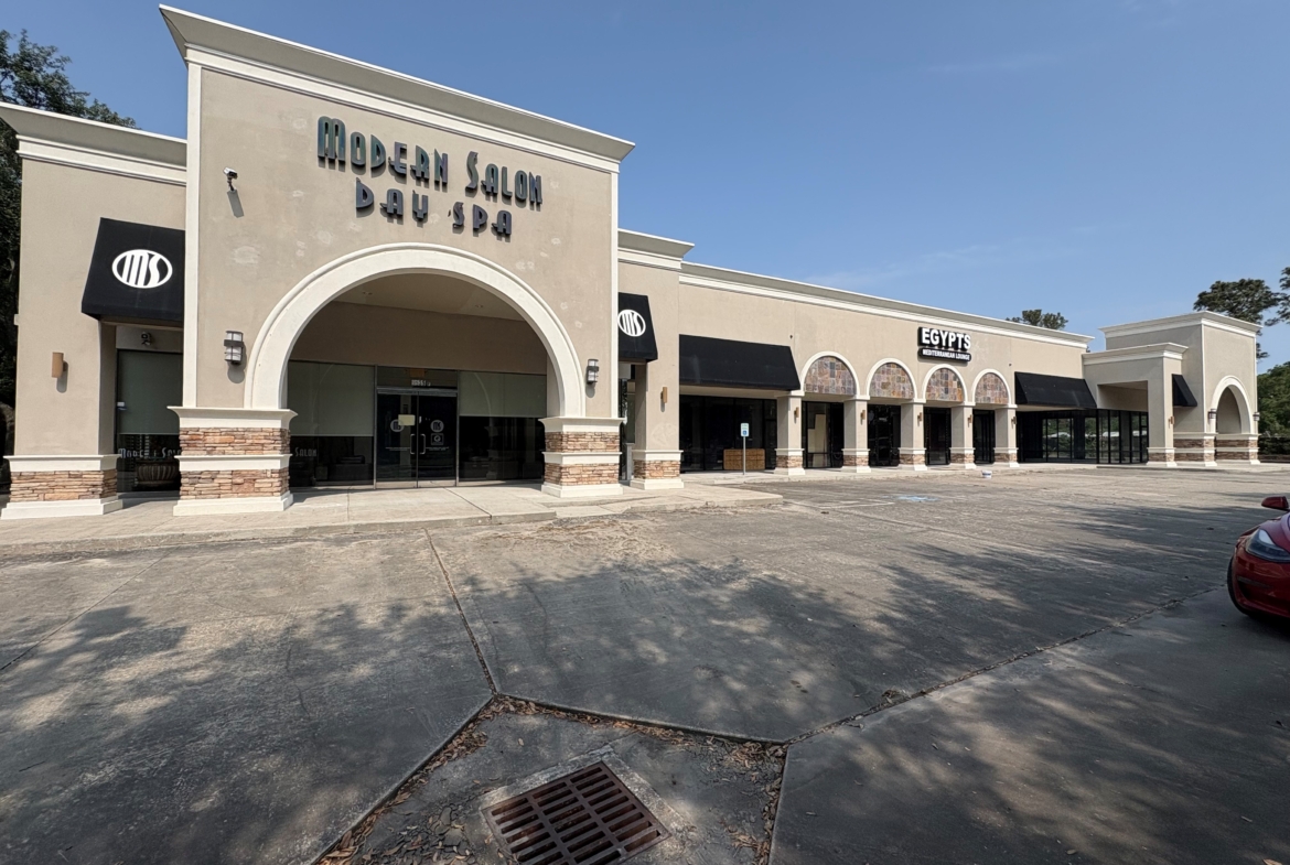 Bright exterior view of a modern salon, day spa, and restaurant space for lease.