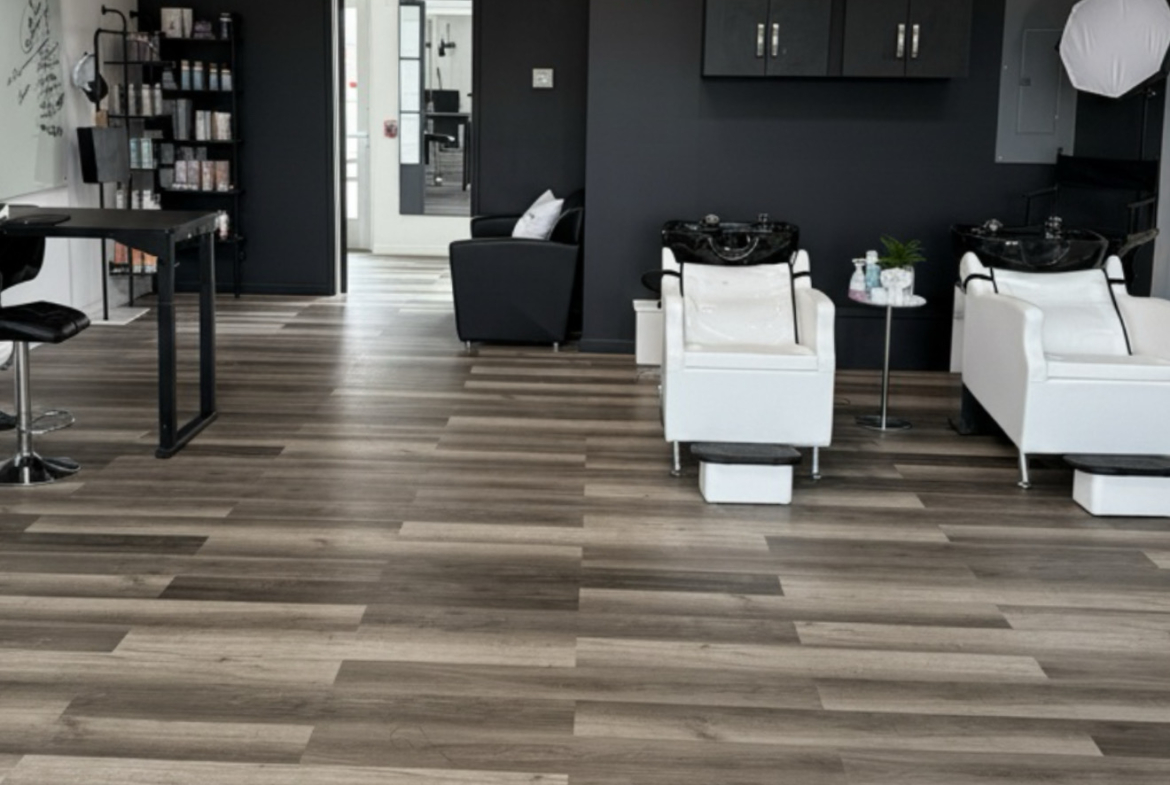 Stylish salon with clean black and white chairs, hair washing stations, and contemporary lighting.