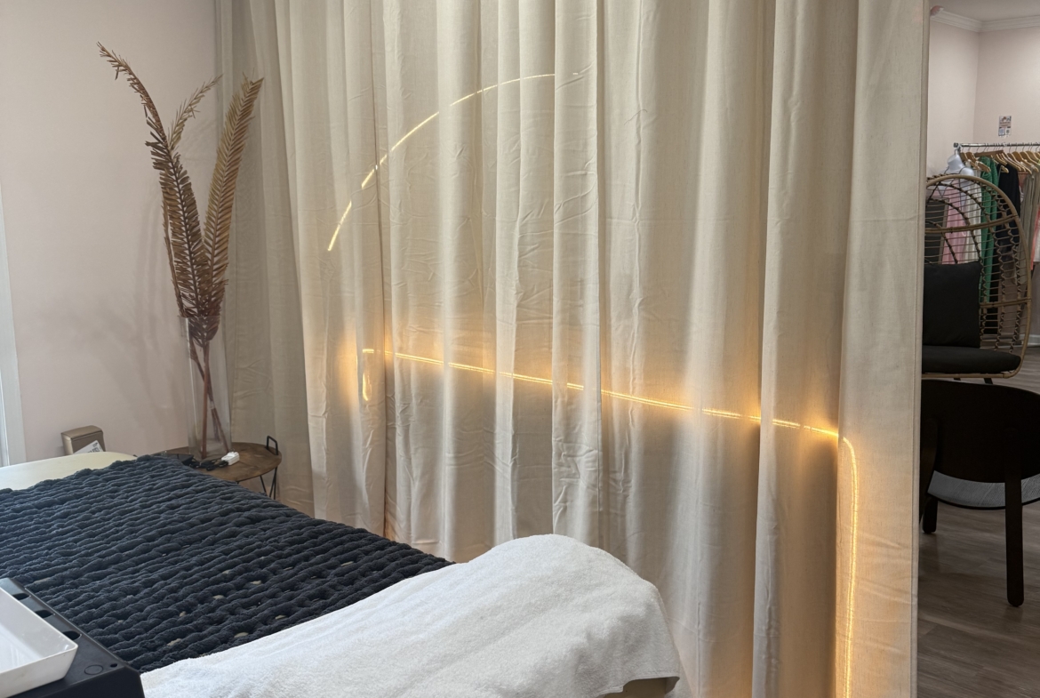 Curated salon room with elegant curtains and soft lighting, perfect for rent or booth space.
