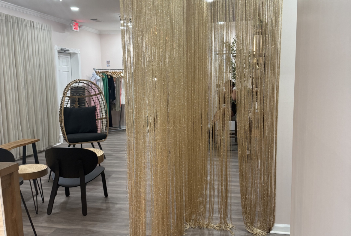 Elegant salon decor featuring gold beaded curtains and contemporary seating.