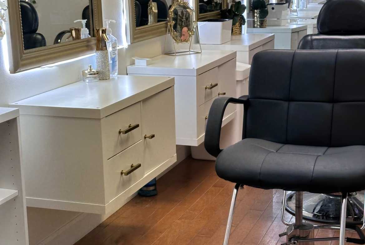 Luxurious hair salon interior with elegant mirrors and decor, ideal for beauty and styling services.