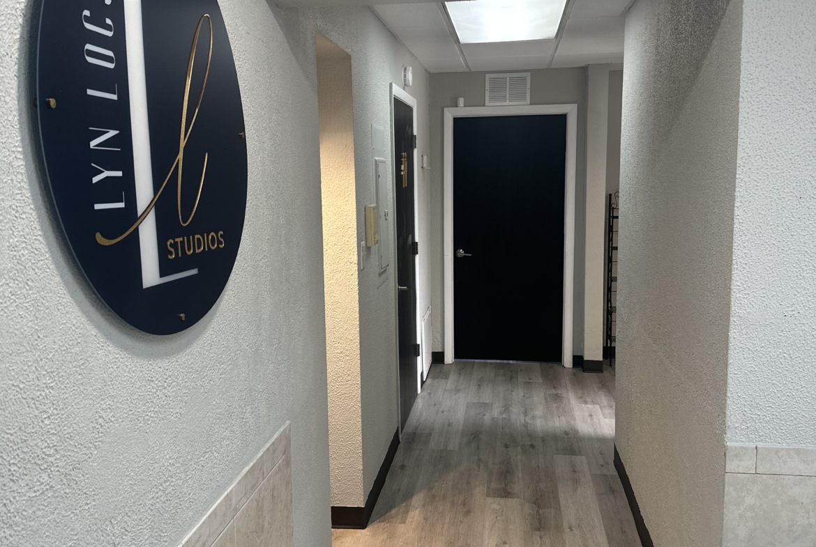 Modern salon studio entrance with stylish signage.