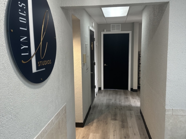 Modern salon studio entrance with stylish signage.