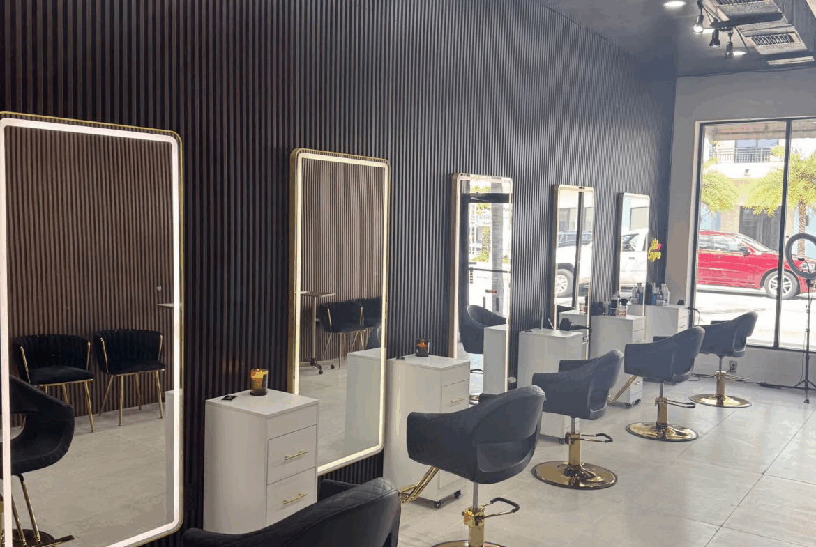 Stylish salon station with sleek mirrors, black chairs, and modern decor for hair cutting and styling.