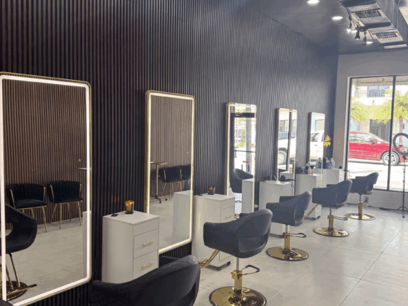 Stylish salon station with sleek mirrors, black chairs, and modern decor for hair cutting and styling.