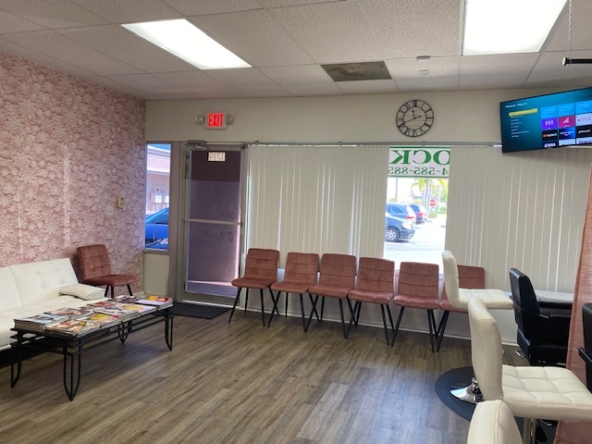 Interior view of a stylish salon waiting area with modern chairs and decor.