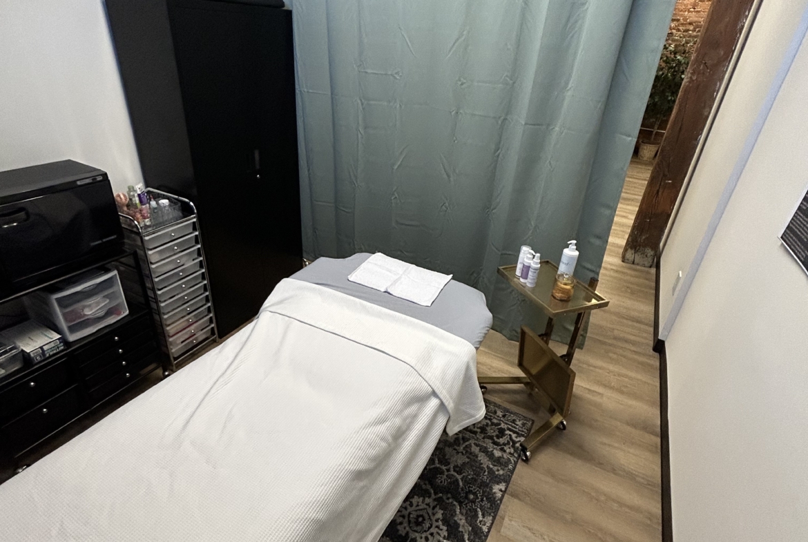 Comfortable massage treatment setup in a cozy salon spa environment.