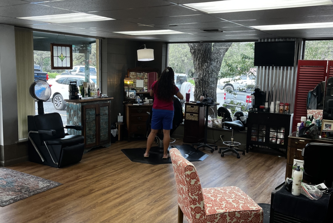 Bright salon space with styling station and large window, perfect for hair styling and beauty services.