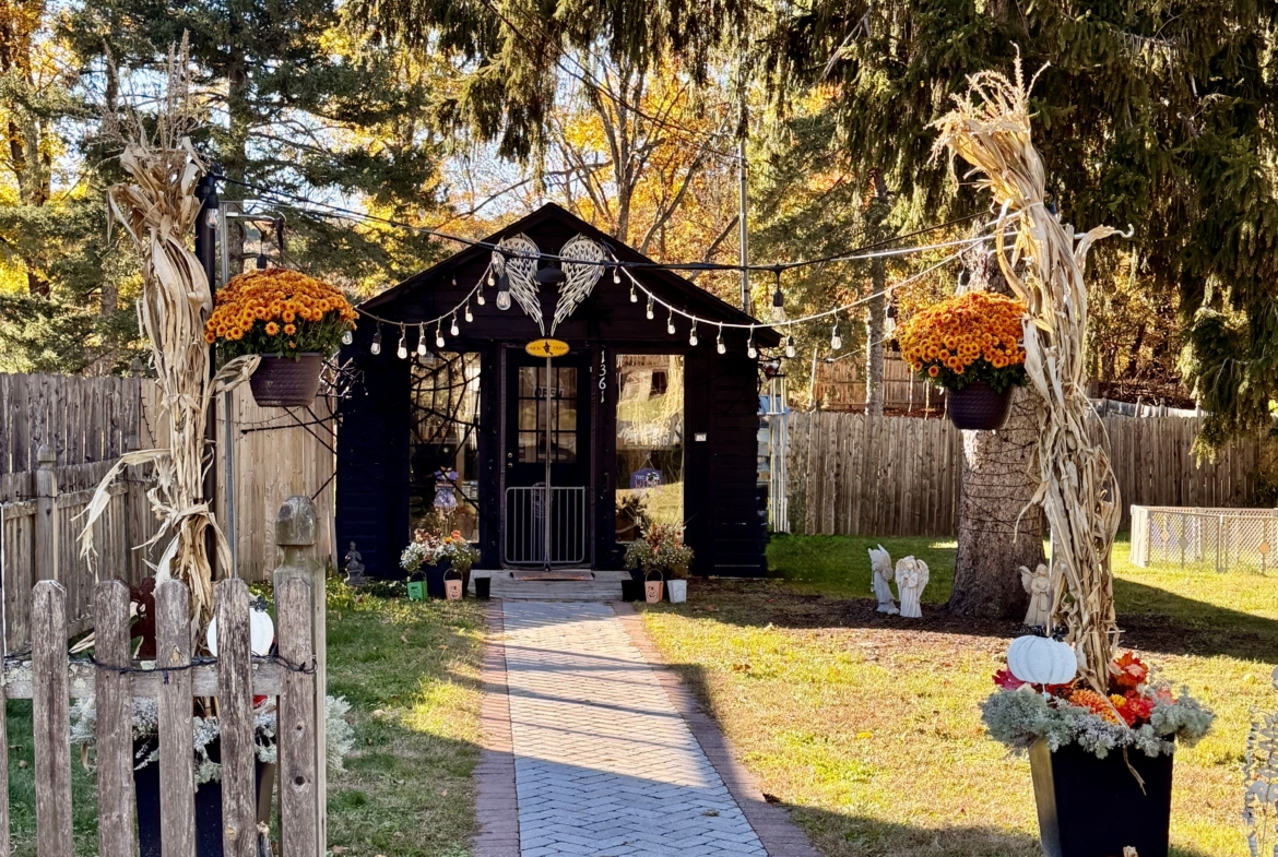 Festive fall outdoor salon setting with pumpkins, decorative corn stalks, and autumn vibes.