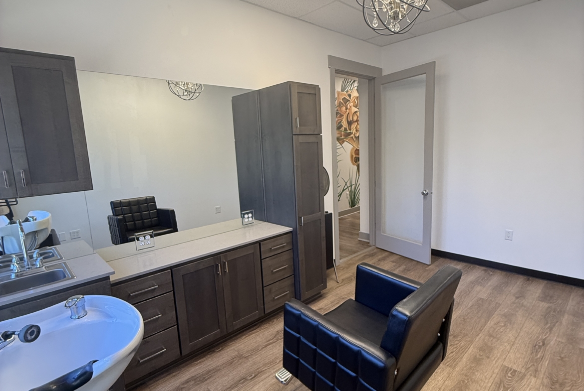 Modern salon rental office with salon chairs and hair washing station. Ideal for beauty professionals.