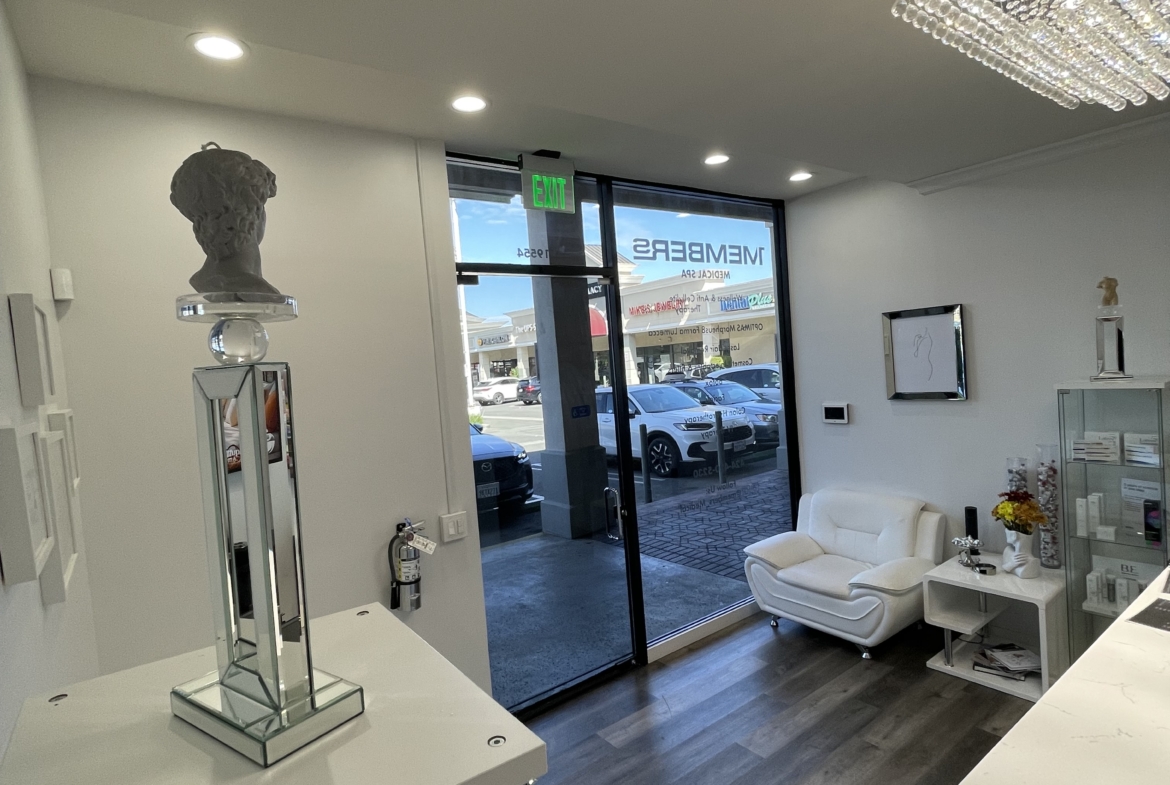 Elegant salon waiting area with white furniture and contemporary decor, perfect for salon renters.