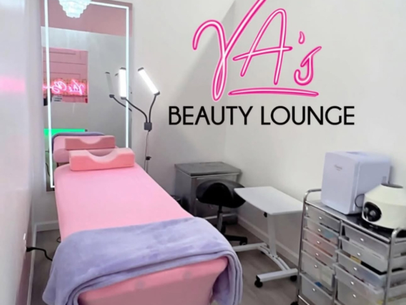 Comfortable beauty lounge with pink spa bed and professional equipment setup.