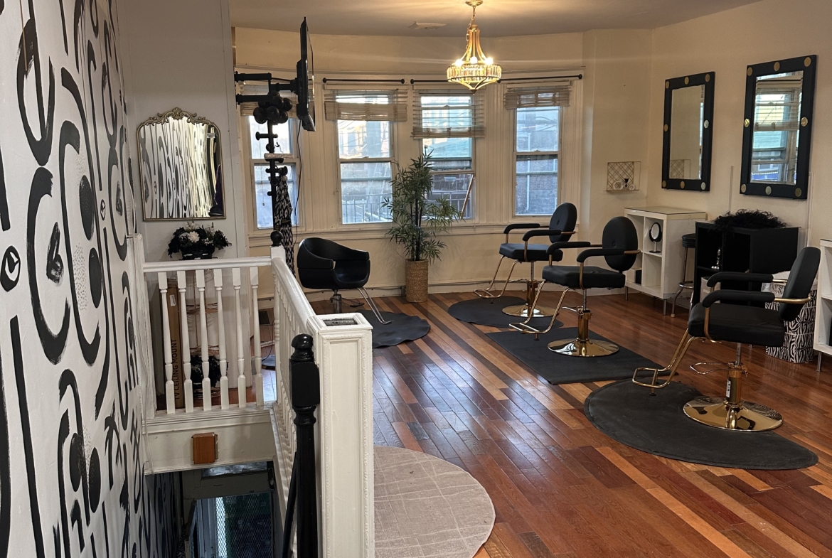 Creative salon space with chairs, mirrors, and decorative lighting for lease | Salon Renter.