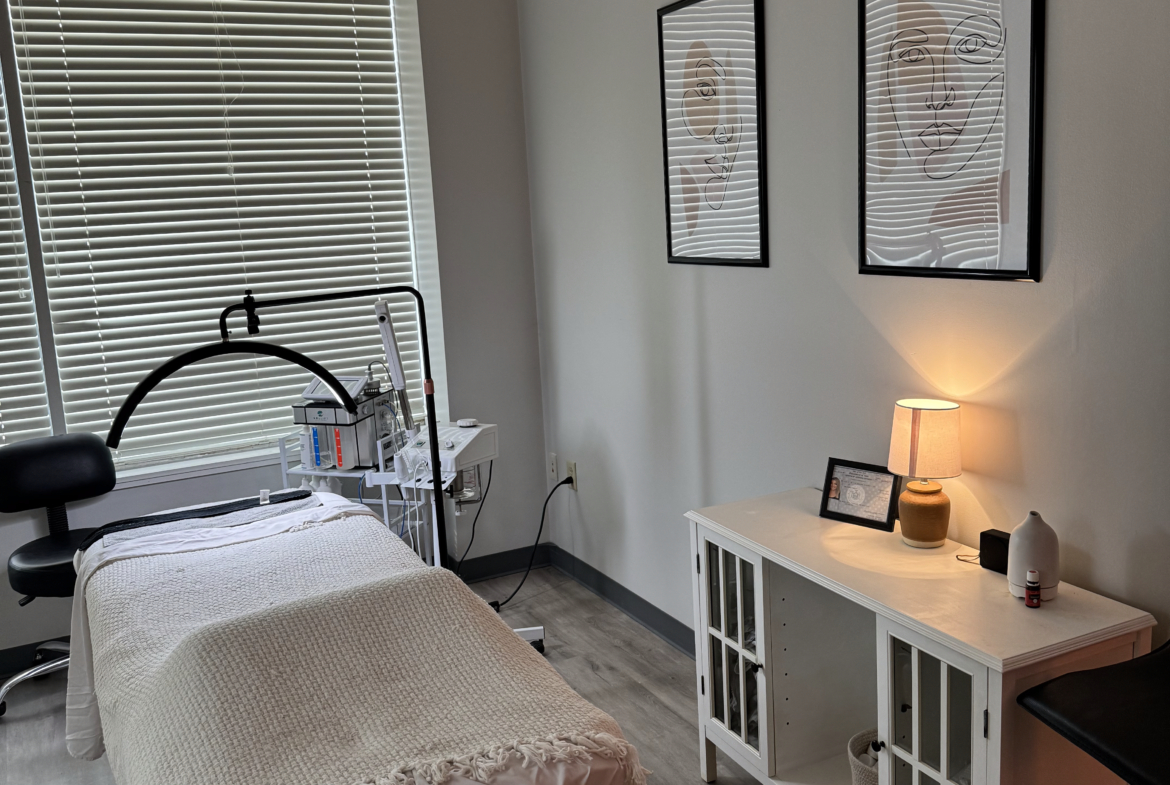 Relaxing beauty treatment room with massage bed, skincare tools, and calming decor.