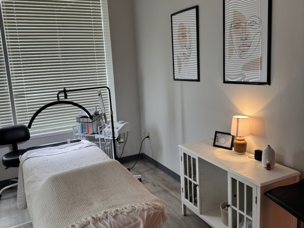 Relaxing beauty treatment room with massage bed, skincare tools, and calming decor.