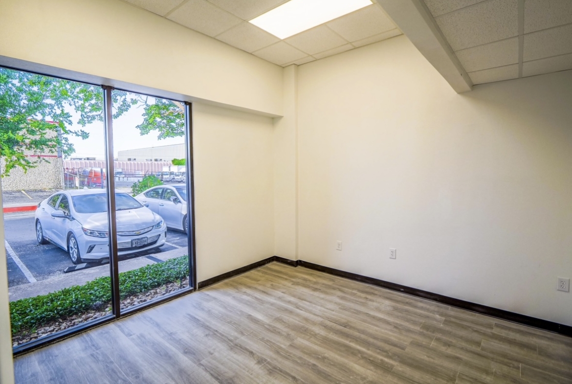 Bright, vacant salon space with natural light and modern flooring, ideal for salon professionals.