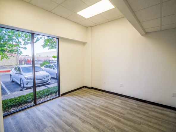 Bright, vacant salon space with natural light and modern flooring, ideal for salon professionals.