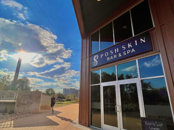 Modern salon with a welcoming bar & spa ambiance outdoors under clear blue skies.