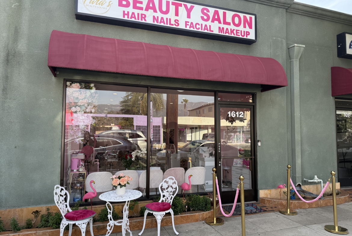 Bright exterior of a beauty salon with pink decorations, elegant furniture, and welcoming atmosphere.
