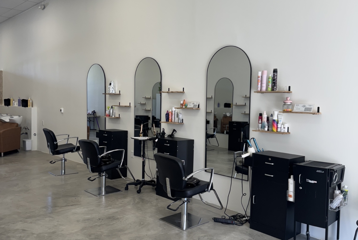 Modern salon with multiple styling stations, mirrors, and professional hairdressing equipment. Easy rental options for beauty professionals.