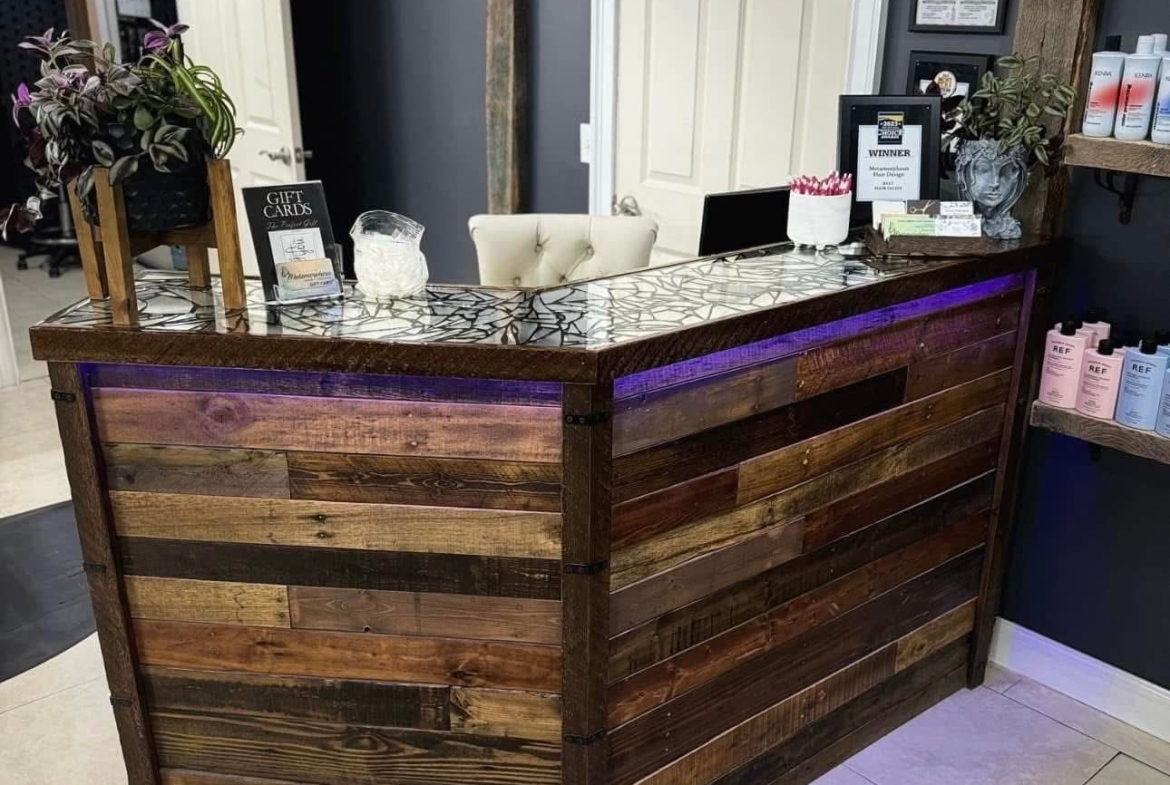 Beautiful salon reception area showcasing a stylish, rustic wood countertop with modern decoration.