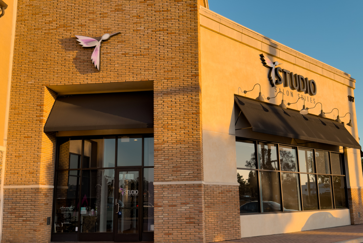 Modern salon building exterior with logo and large windows, inviting for beauty services.