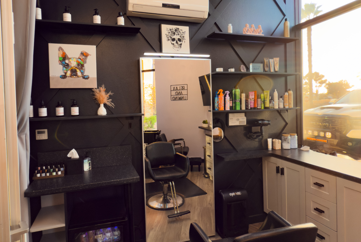 Stylish salon interior with black and white accents, beauty products, and modern lighting for a luxury salon experience.