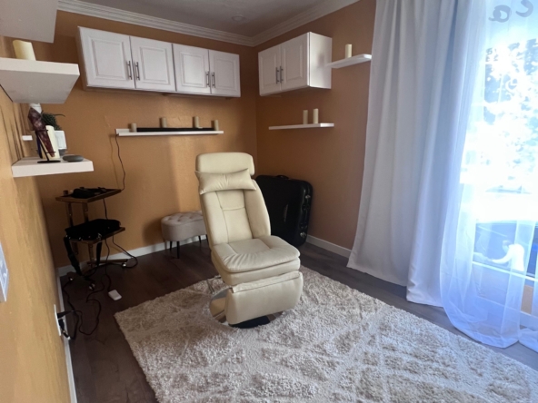 Comfortable salon workspace with chair, storage, and decor, ideal for salon rental or leasing.