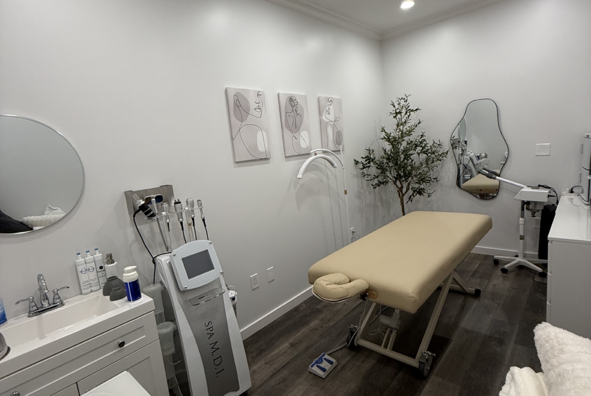 Comfortable beauty spa treatment room with massage table and professional skincare equipment. Perfect for salons and estheticians.
