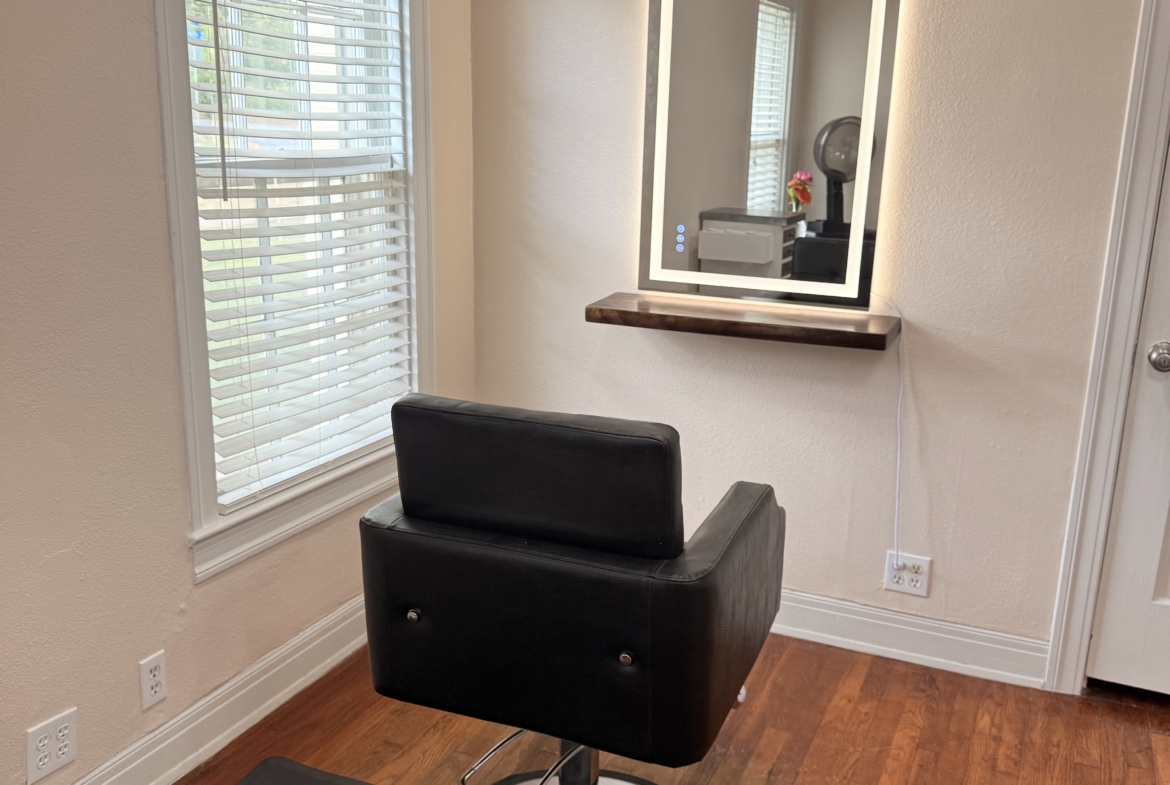 Stylish salon chair with illuminated mirror for hair and beauty services.