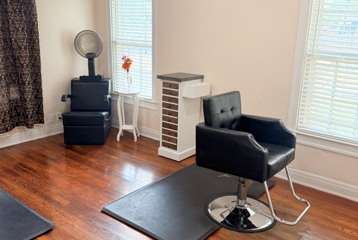Stylish hair salon interior featuring salon chairs, hair station, and large windows for natural lighting.
