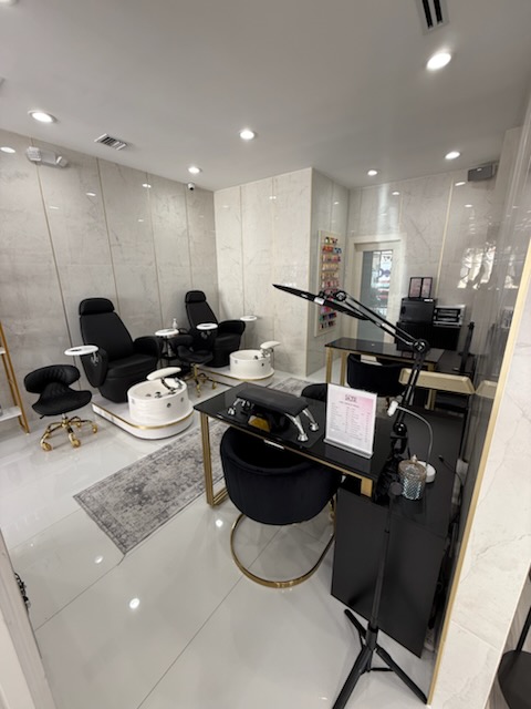 Modern salon spa treatment area with comfortable chairs and professional equipment.