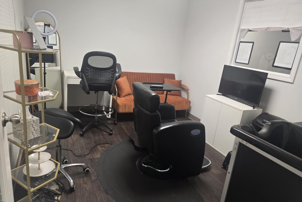 Comfortable salon rental space featuring chairs, a TV, and a relaxing waiting area.