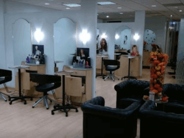 Beautiful salon with stations and comfortable seating for clients and stylists.