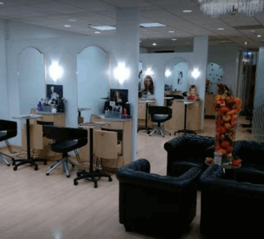 Beautiful salon with stations and comfortable seating for clients and stylists.
