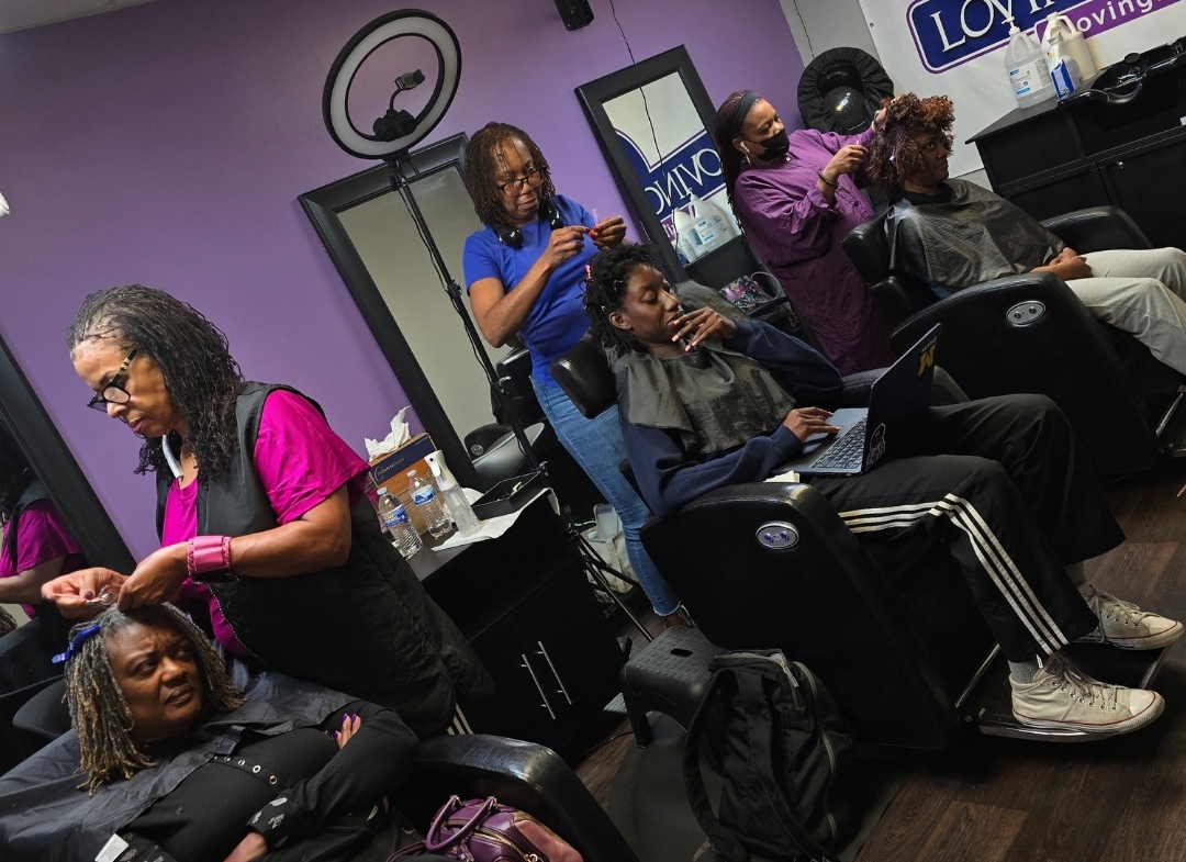 2. Hair stylists working on clients in a modern salon setting.
