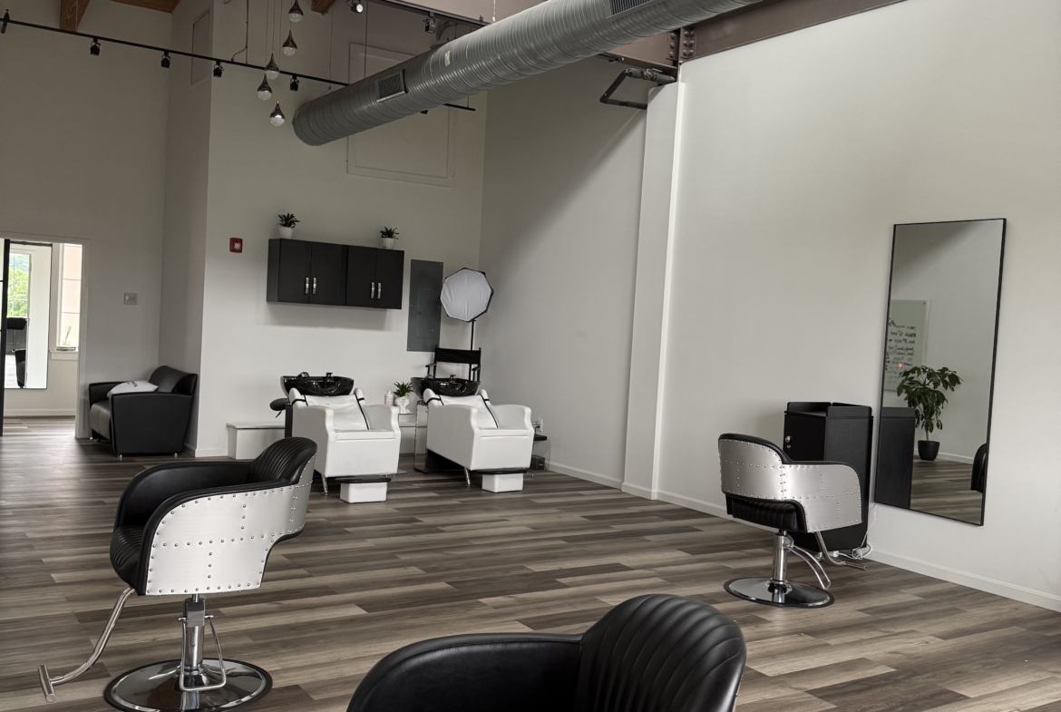 Stylish salon chairs and wash stations in a contemporary hair and beauty salon interior.