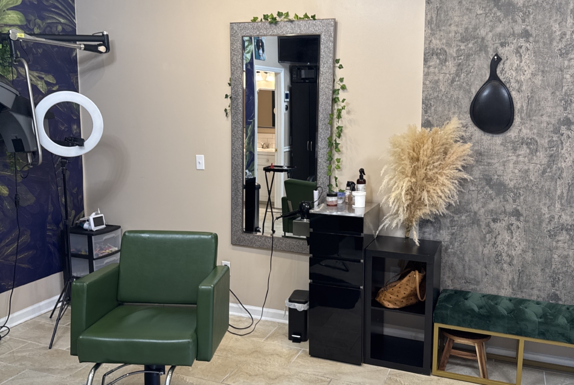 Stylish salon interior featuring a green salon chair, mirror, and professional hairstyling equipment.