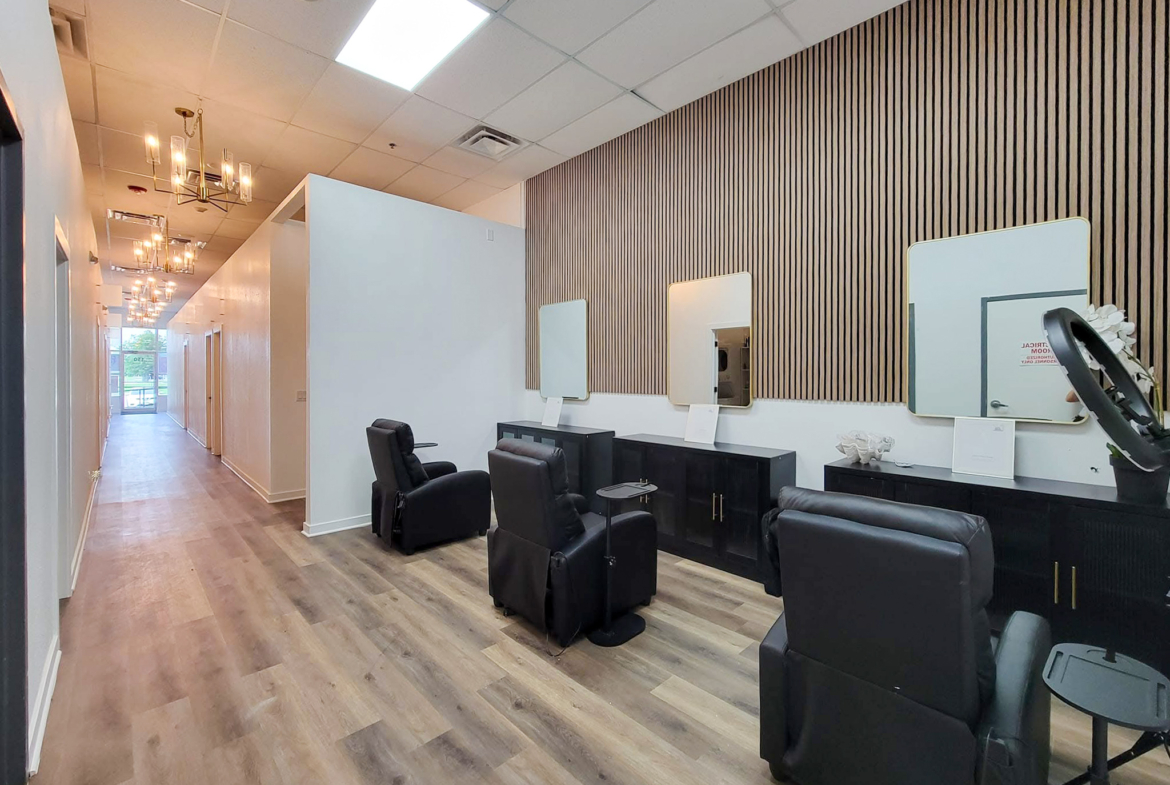 Bright and stylish salon interior with multiple mirrors and lounge chairs for clients.