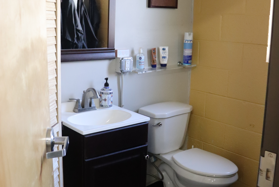 Clean salon bathroom with sink and toiletries.