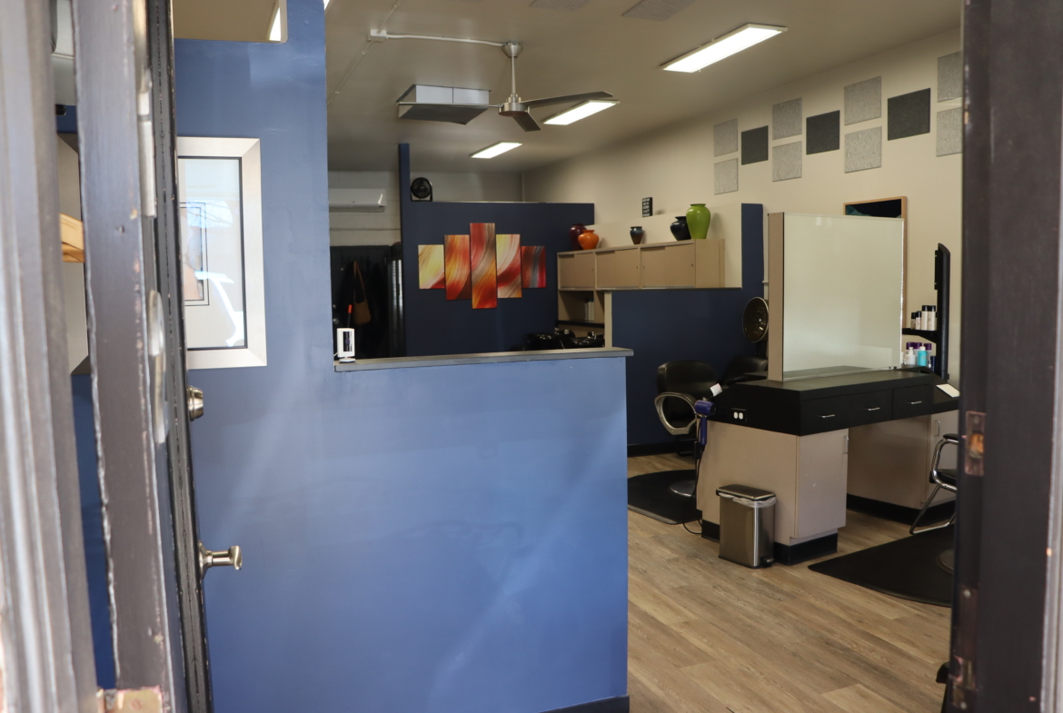 Bright salon space with chairs, mirrors, and styling stations.