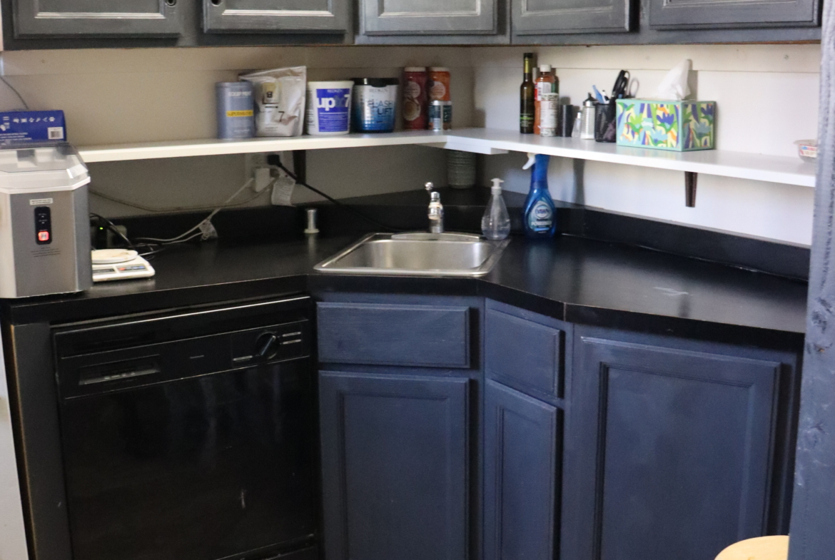 Salon Renter commercial kitchen setup with dark cabinetry and essential appliances.