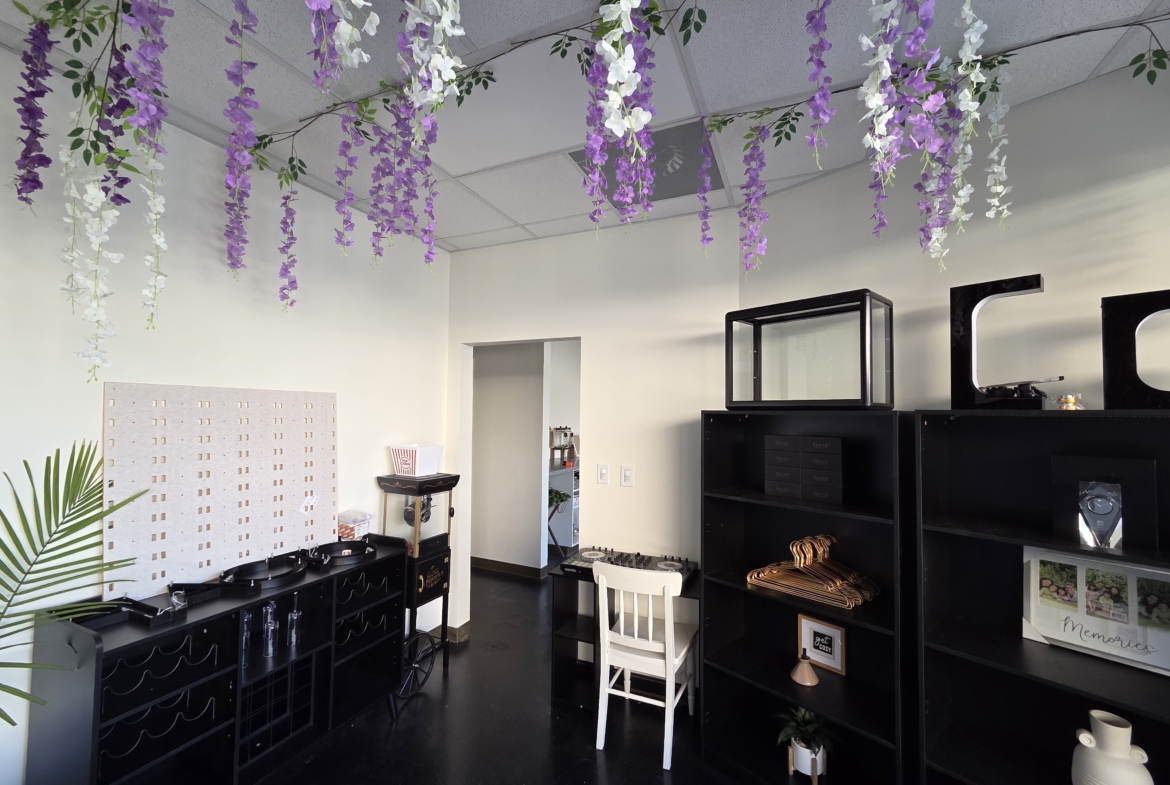 Bright salon space with floral ceiling decor and modern styling stations.