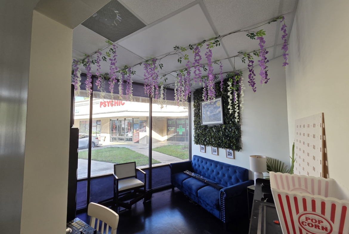 Bright salon with floral ceiling decor and cozy seating area for clients.